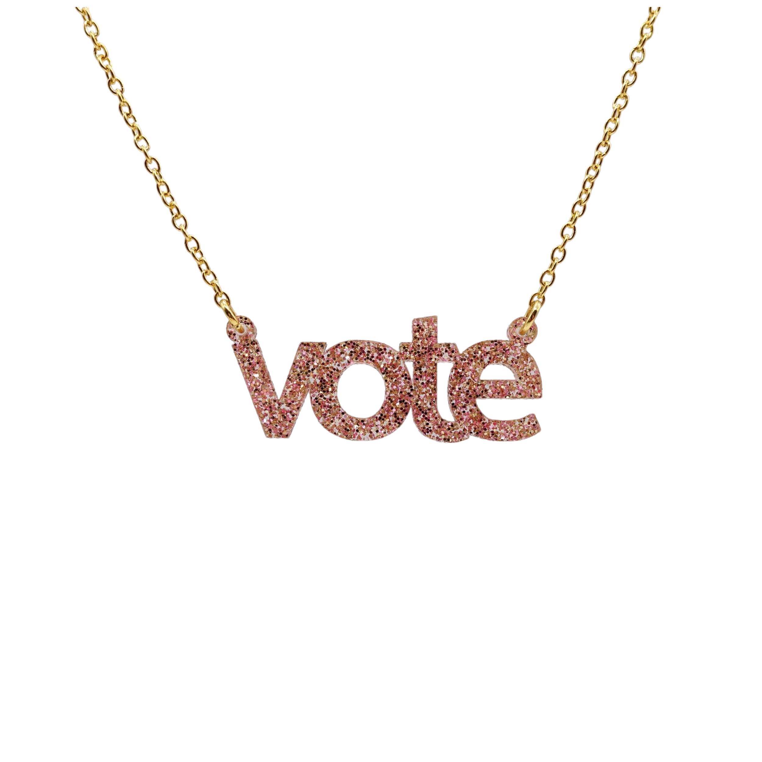 Vote necklace in pink fizz glitter shown hanging against a white background. 