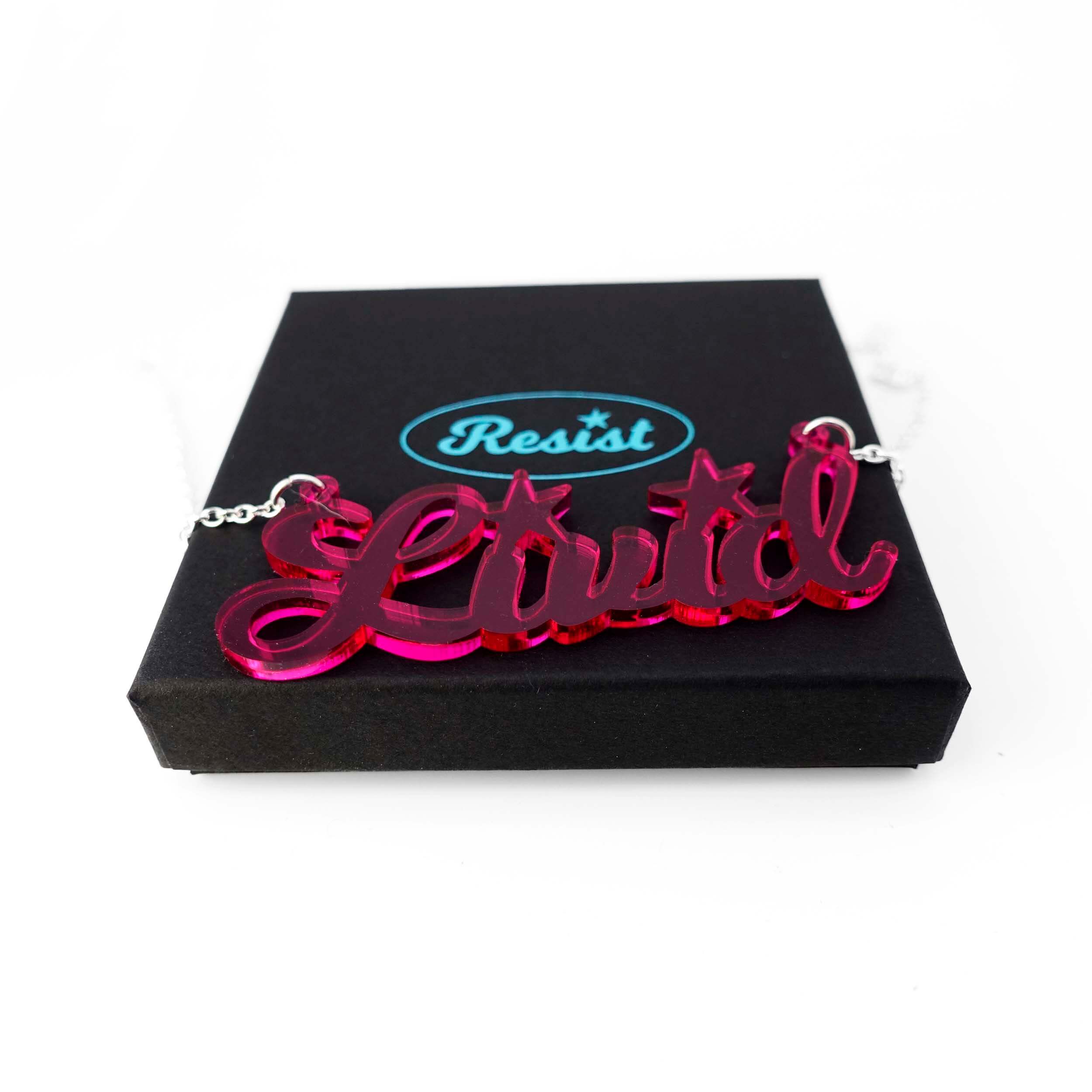 Livid necklace in hot pink shown on a Wear and Resist gift box. 