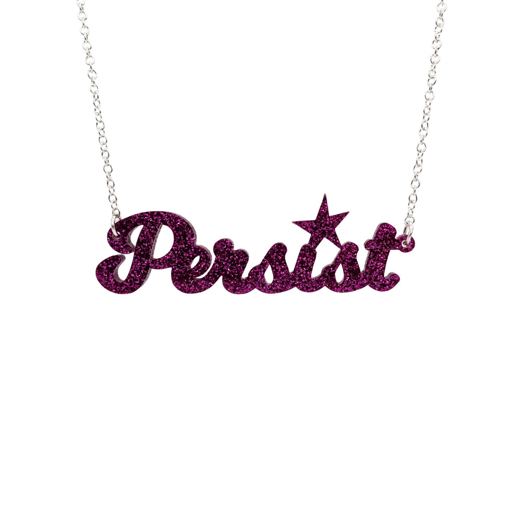 Purple glitter script Persist necklace shown hanging against a white background. 