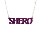 Purple glitter Shero necklace shown in a Wear and Resist gift box. 