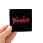 Chilli red disco Persist necklace shown held up in a Wear and Resist gift box. 