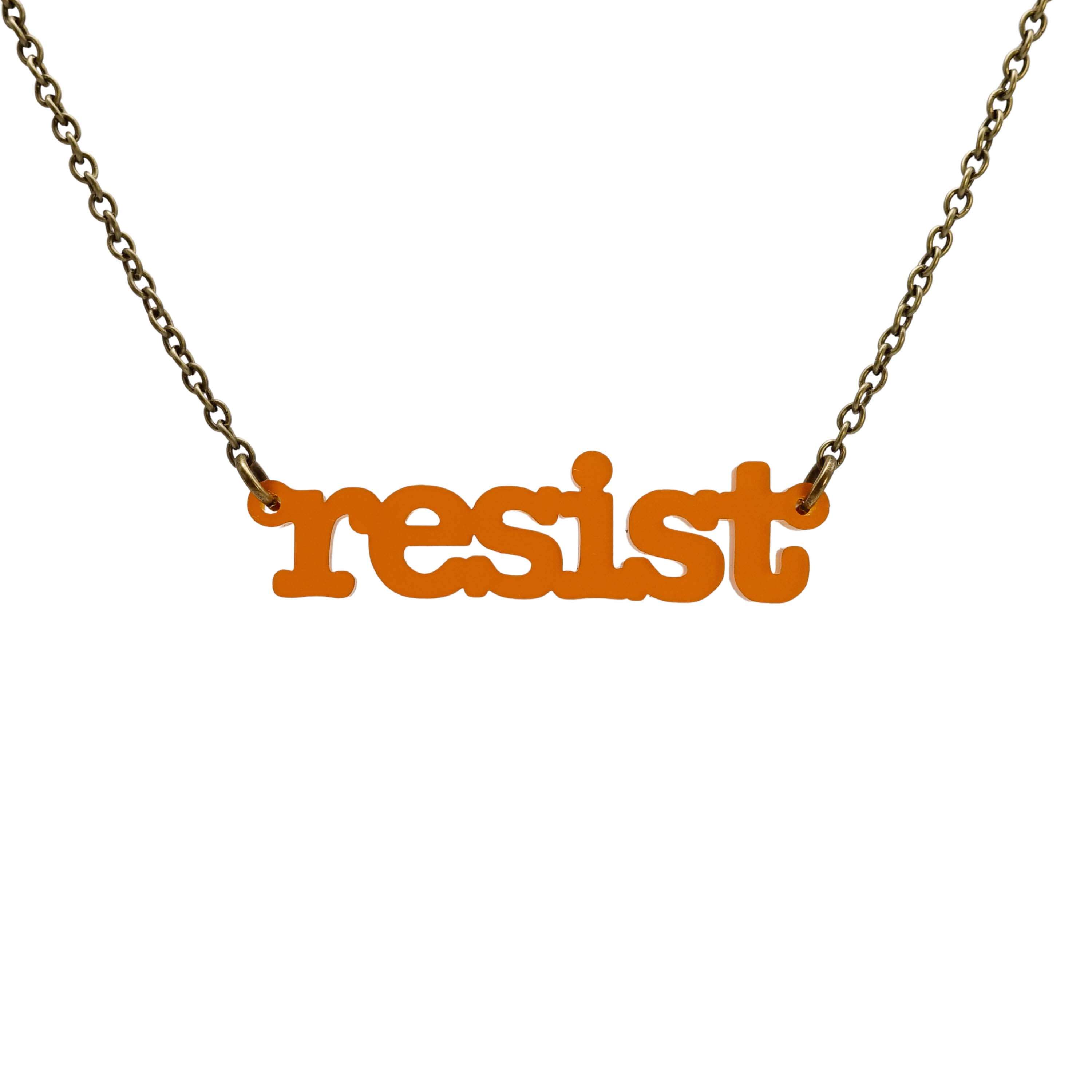 Typewriter Resist necklace in cider frost shown hanging on an antique gold chain against a white background. 