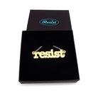 Typewriter Resist necklace in matte iridescent shown in a Wear and Resist gift box. 