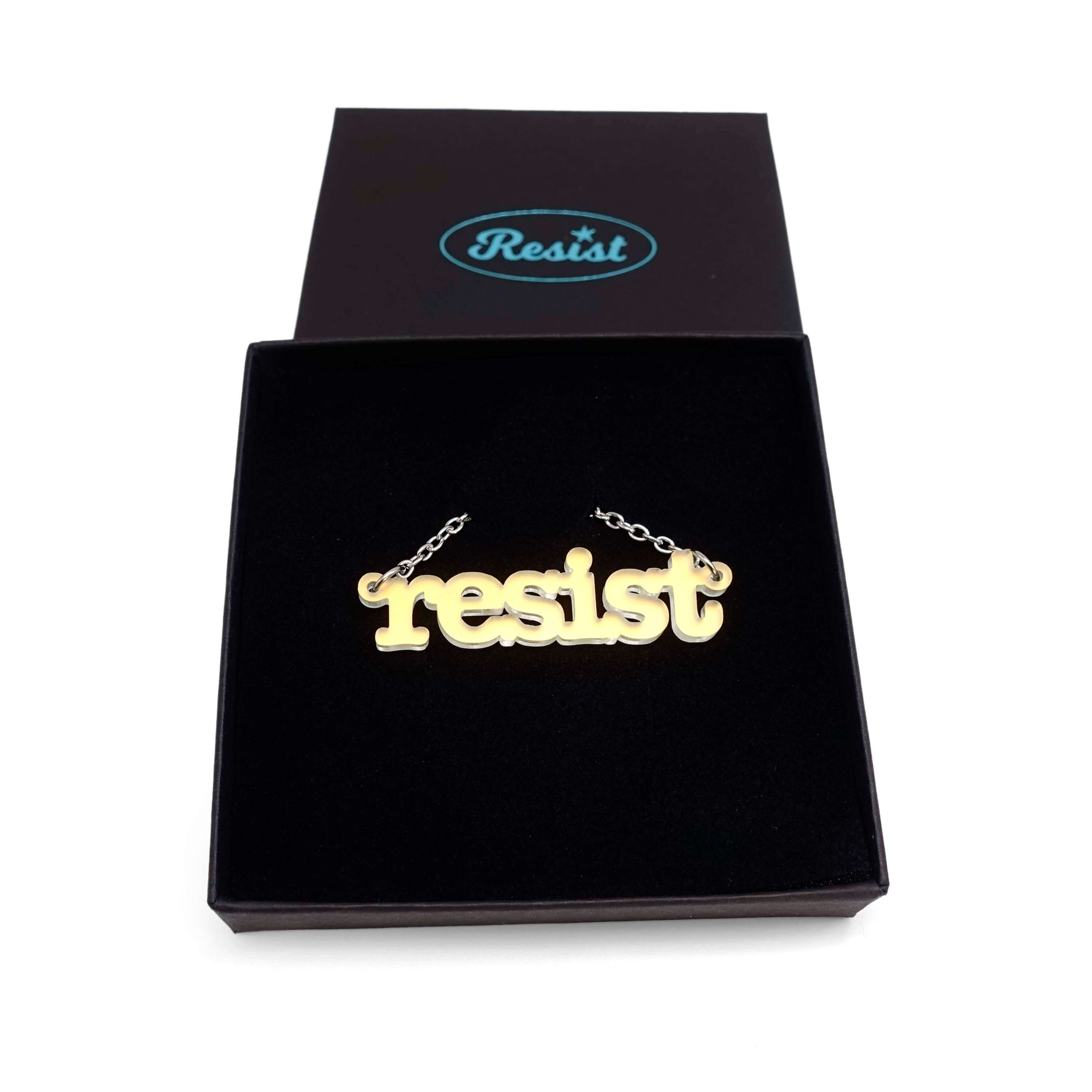 Typewriter Resist necklace in matte iridescent shown in a Wear and Resist gift box. 