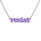 Typewriter Resist necklace in parma violet shown hanging on a stainless steel chain against a white background. 