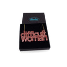 Difficult Woman necklace in rose glitter, shown in a Wear and Resist gift box.