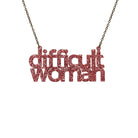 Difficult Woman necklace in rose glitter, shown hanging against a white background. 