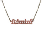 Irish Gaelic Feiminí necklace in rose glitter, shown hanging against a white background. 