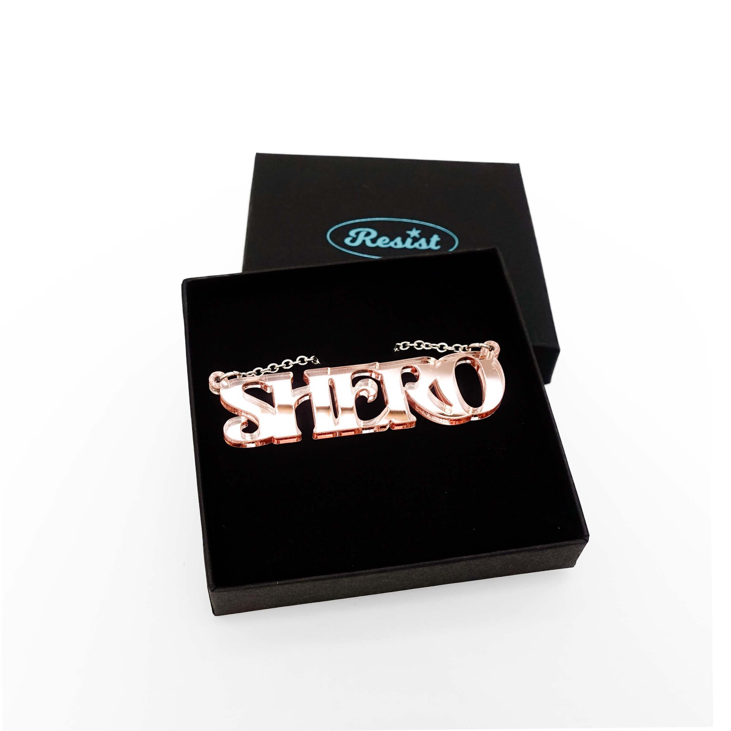 Rose gold mirror Shero necklace shown in a Wear and Resist gift box. 