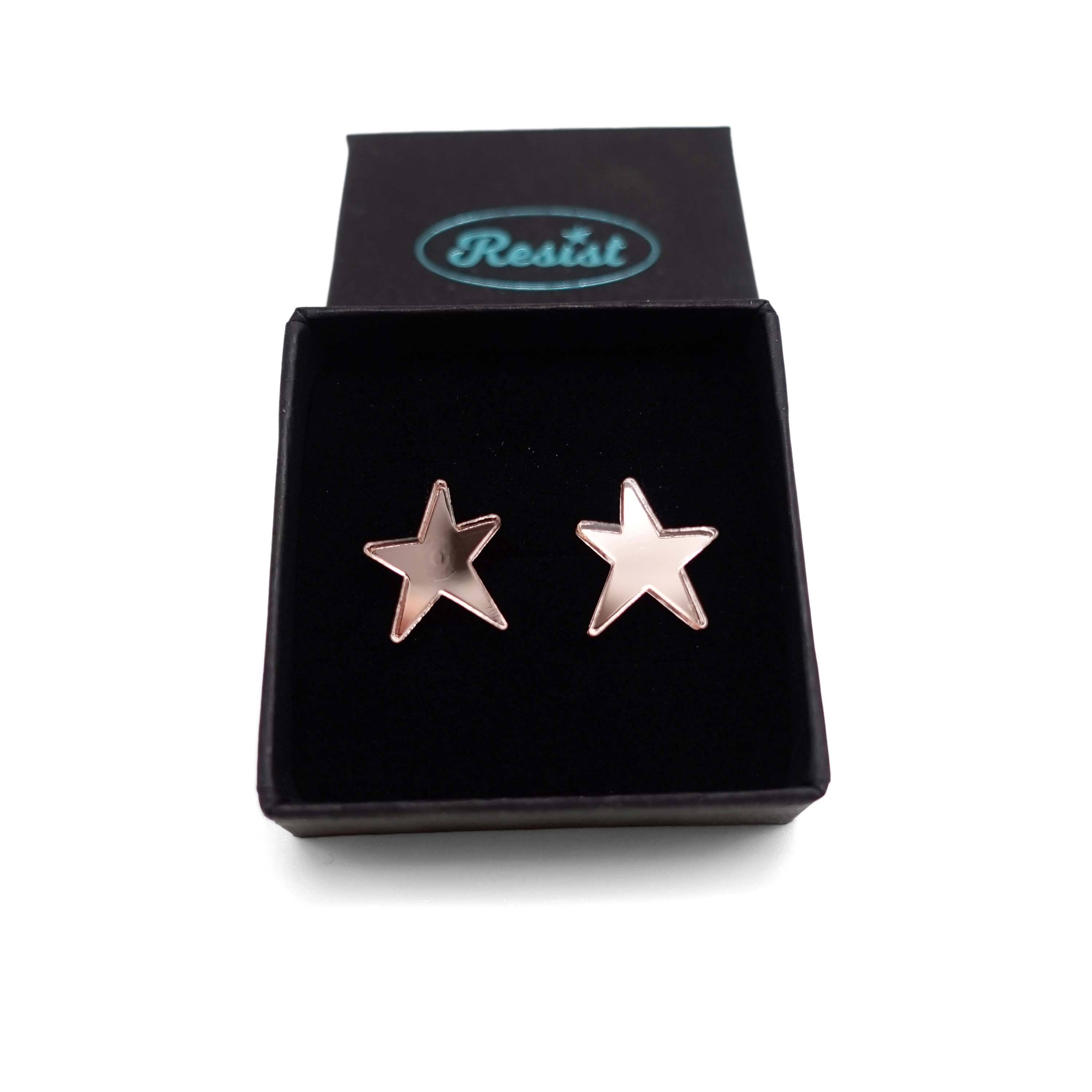 Rose gold mirror funky Resist star earrings shown in a Wear and Resist gift box. 