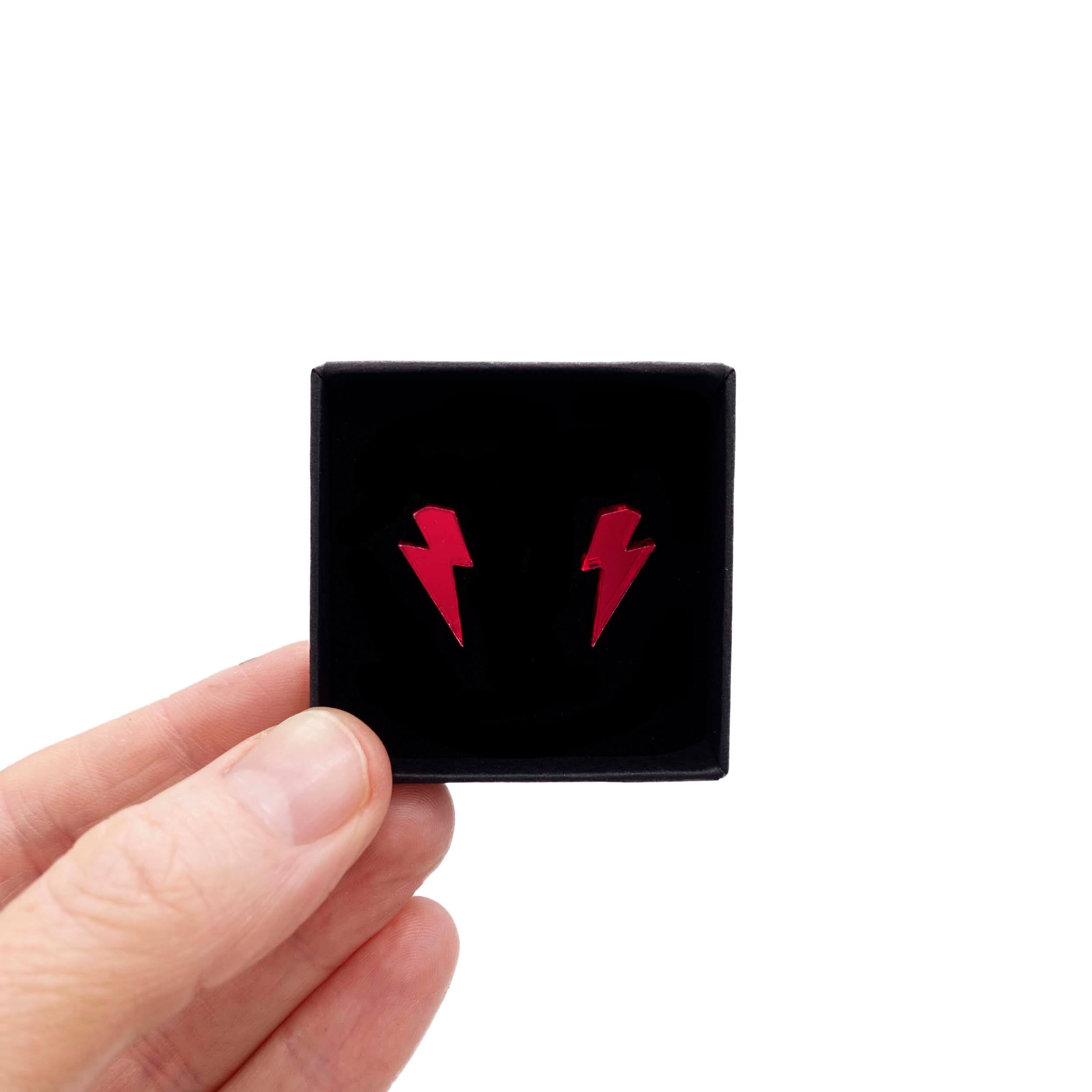 Tiny lightning bolt earrings in ruby red mirror. 