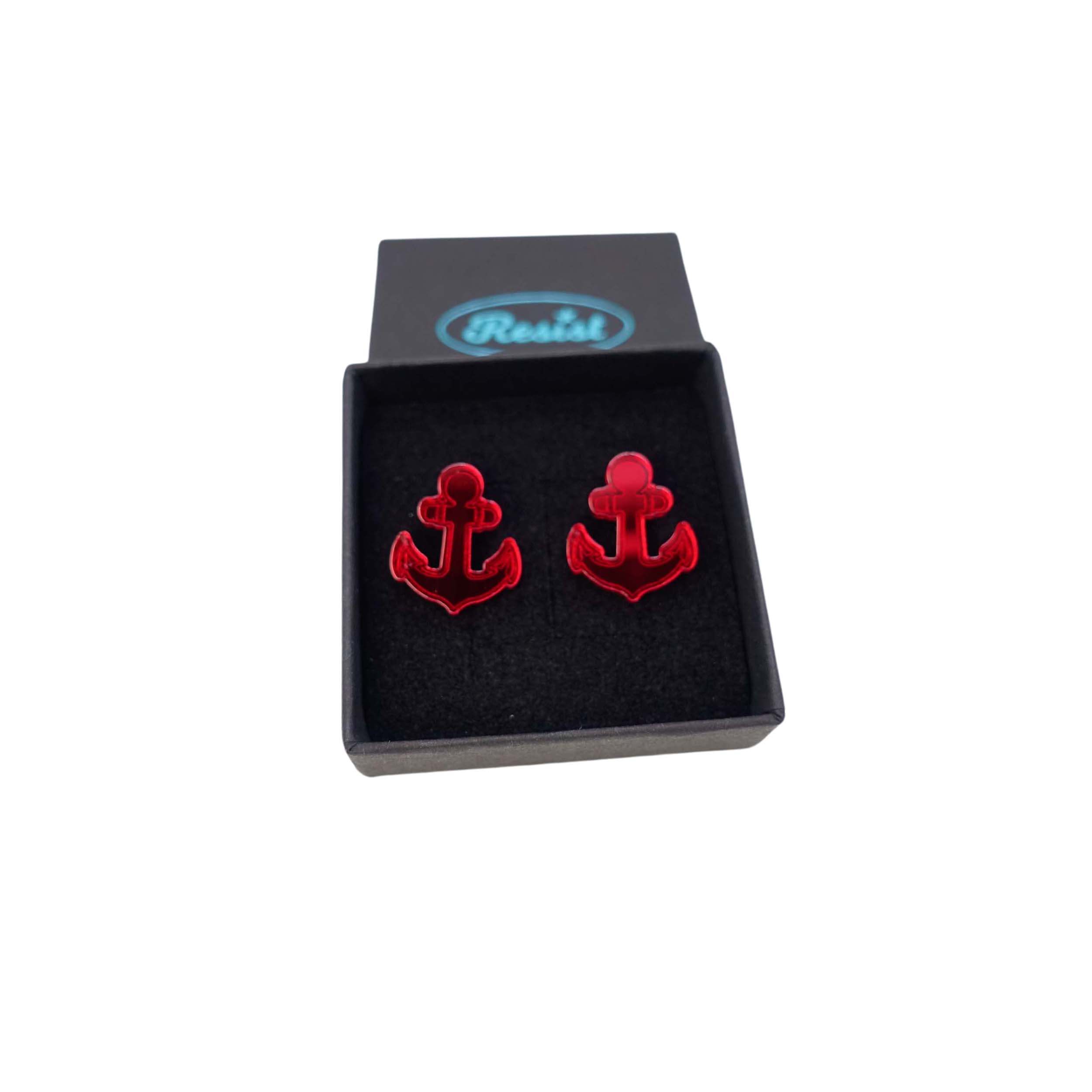 Ruby red mirror little anchor earrings shown in a Wear and Resist gift box. 
