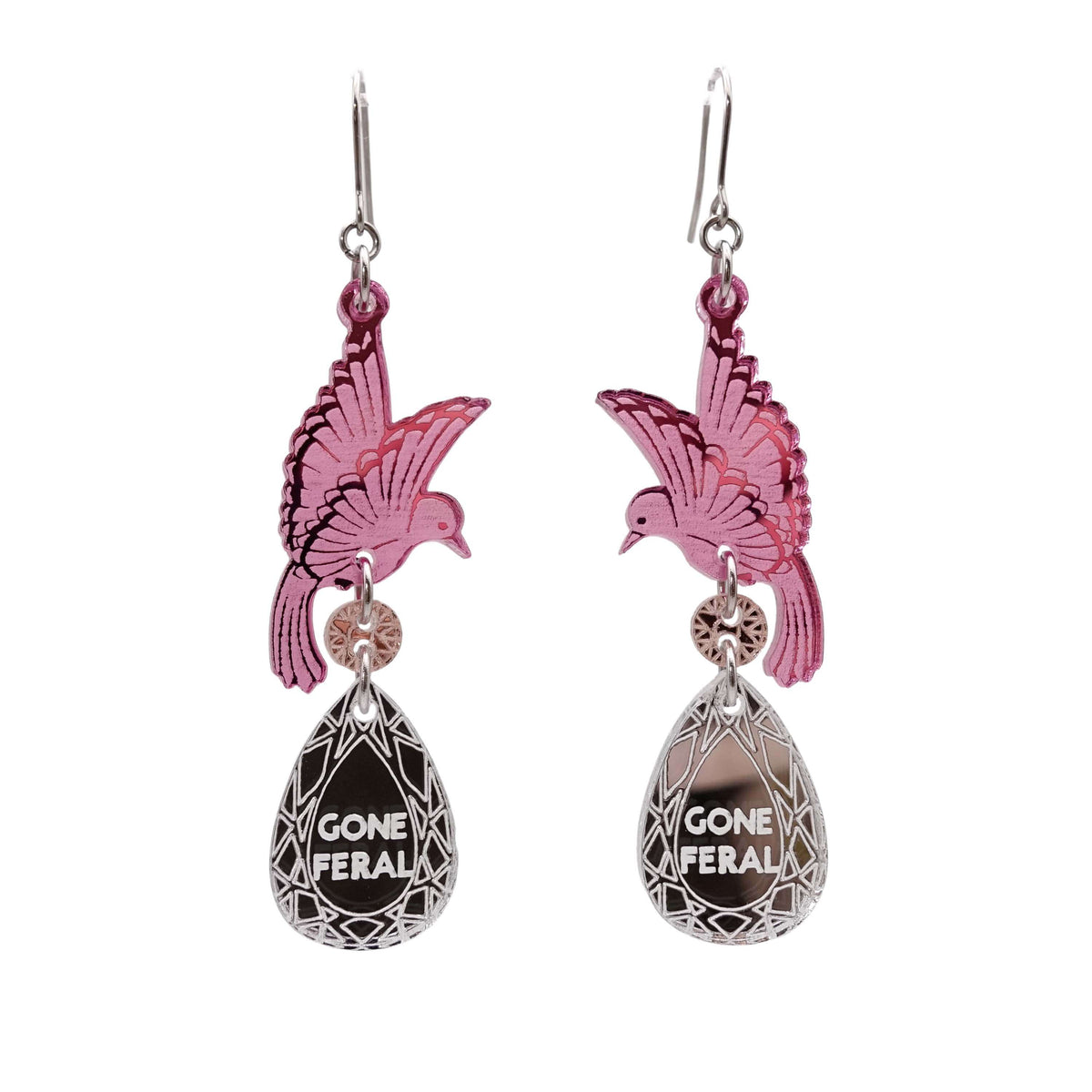 A pair of acrylic earrings with pink birds holding silver 'jewels' that say 'Gone Feral'. 