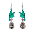 A pair of acrylic earrings with green birds holding silver 'jewels' that say 'Nah' and 'Nope'.