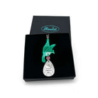 An acrylic pendant necklace with a green bird holding a silver 'jewel' that says 'What Fresh Hell'. Shown in a Wear & Resist gift box. 