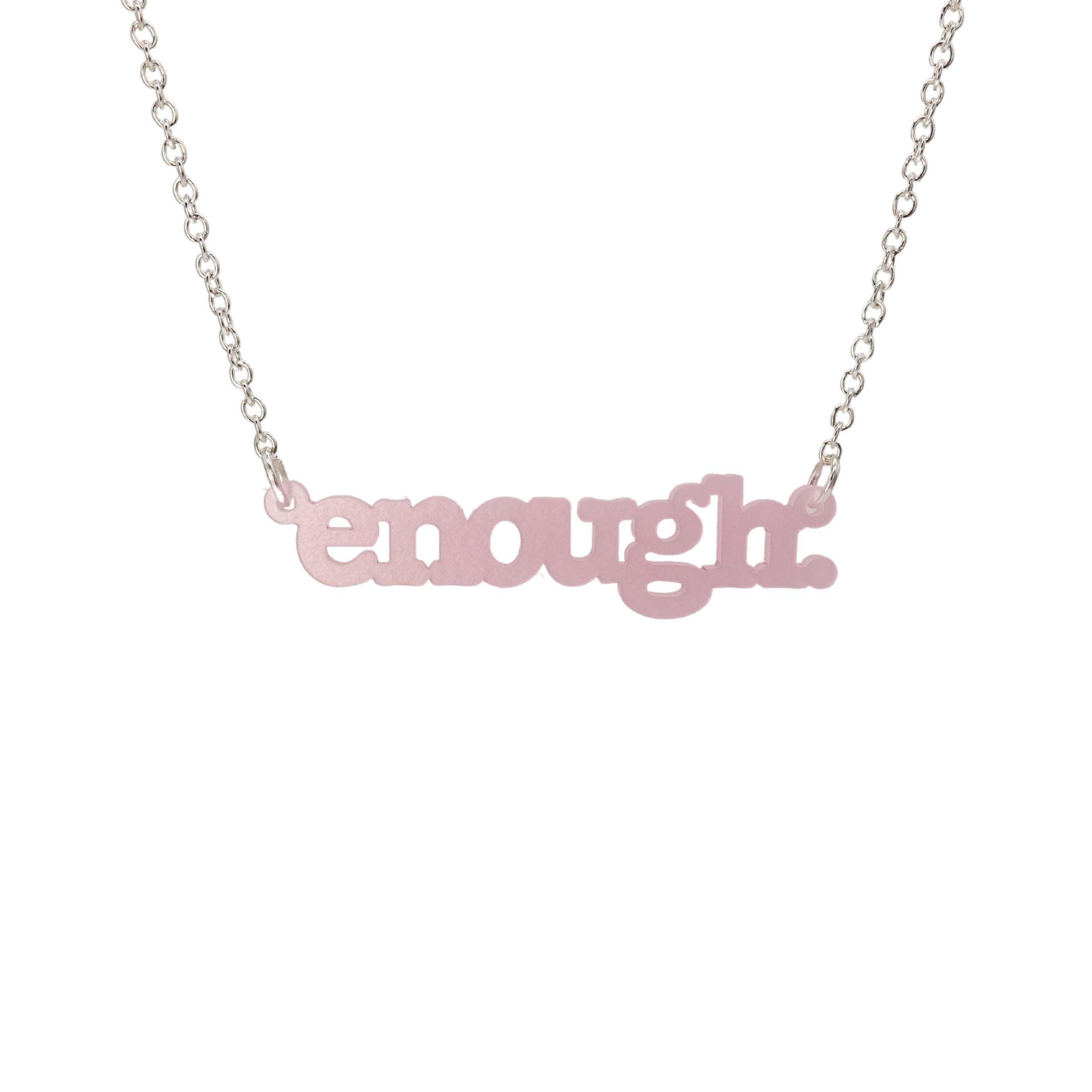 Shell pink Enough necklace shown hanging on a silver chain against a white background. 