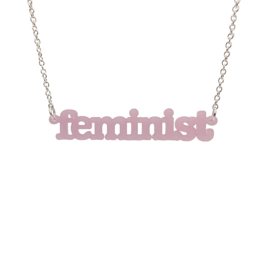  Shell pink Feminist necklace shown hanging on a white background. 