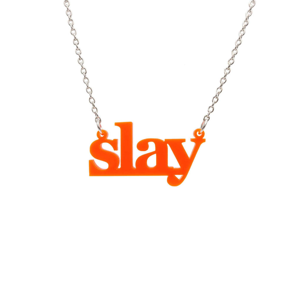 Slay necklace in fluoro orange on a silver chain shown hanging against a white background. Designed by Sarah Day for Wear and Resist. £2 goes to Women for Refugee Women charity. 