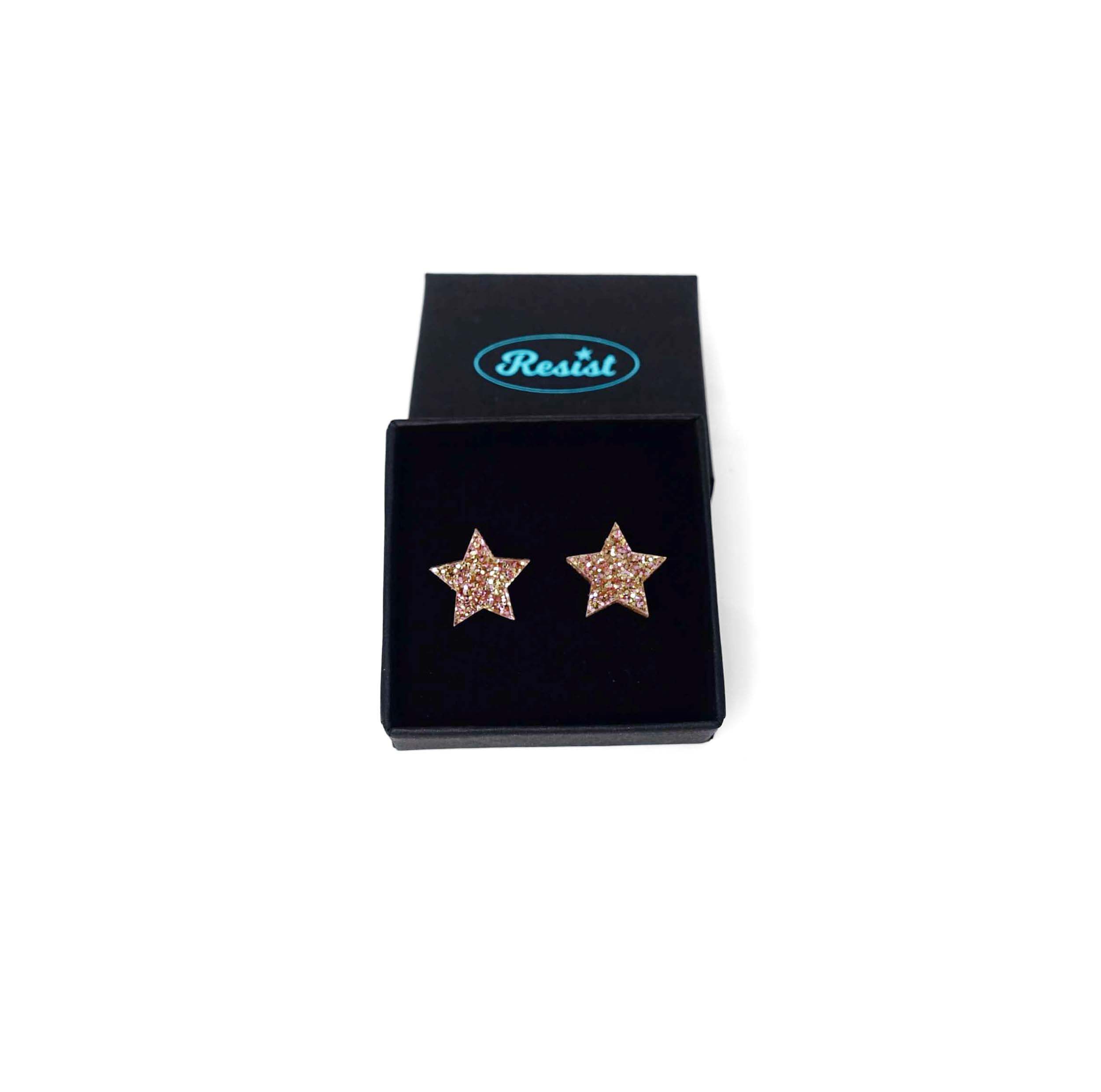 Big star earrings in pink fizz glitter shown in a Wear and Resist gift box. 