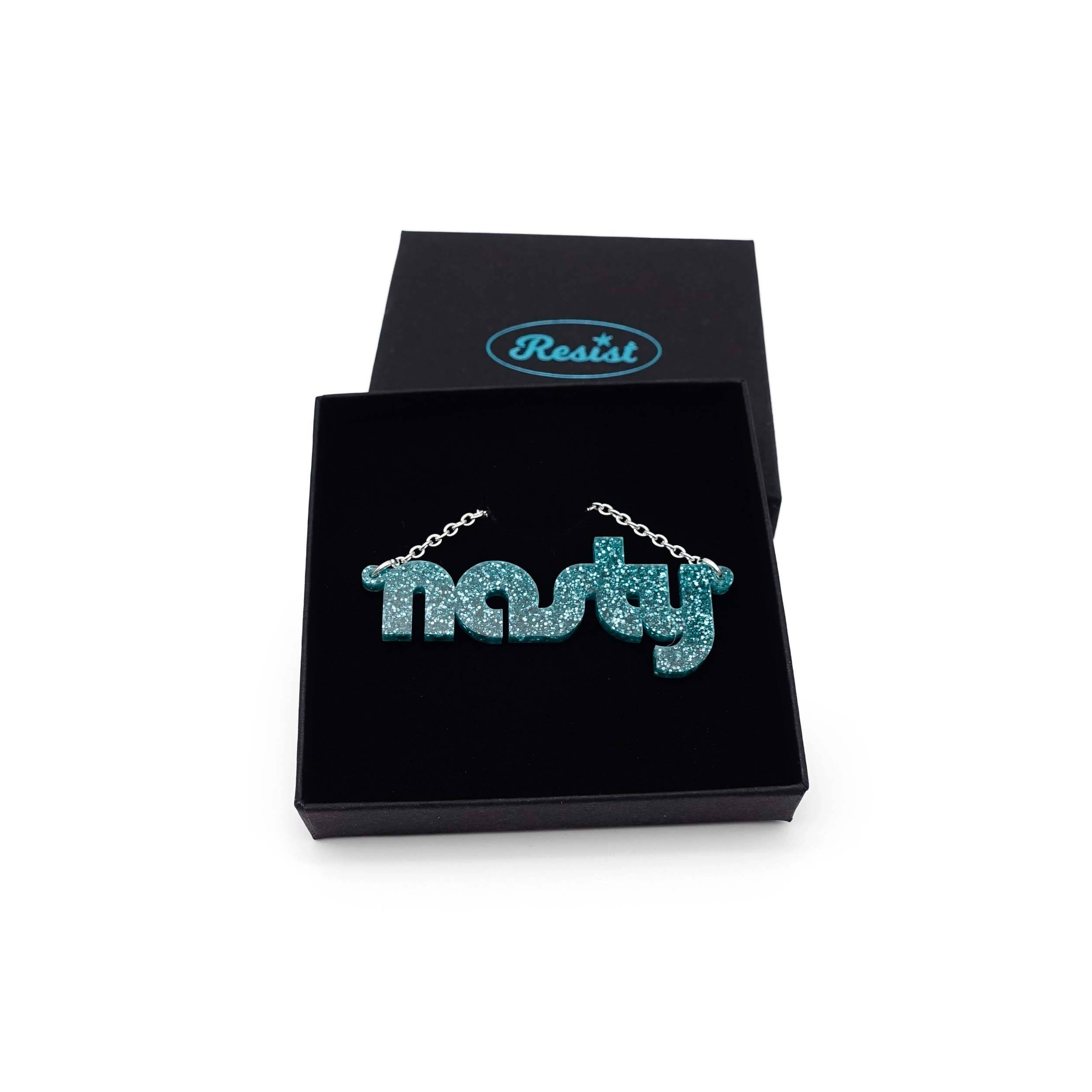 Nasty necklace in teal glitter, shown in a Wear and Resist gift box. 