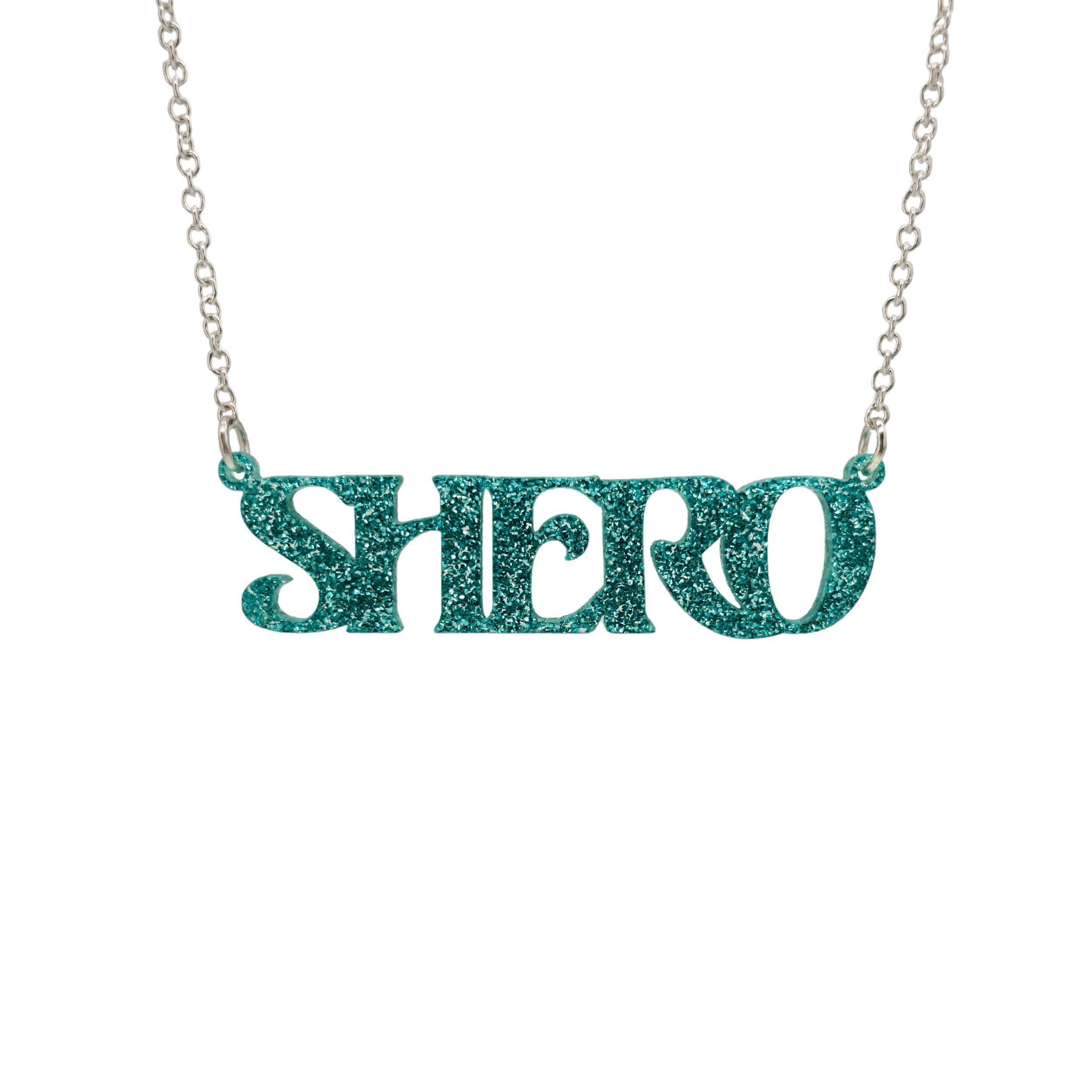 Teal glitter Shero necklace shown in a Wear and Resist gift box. 
