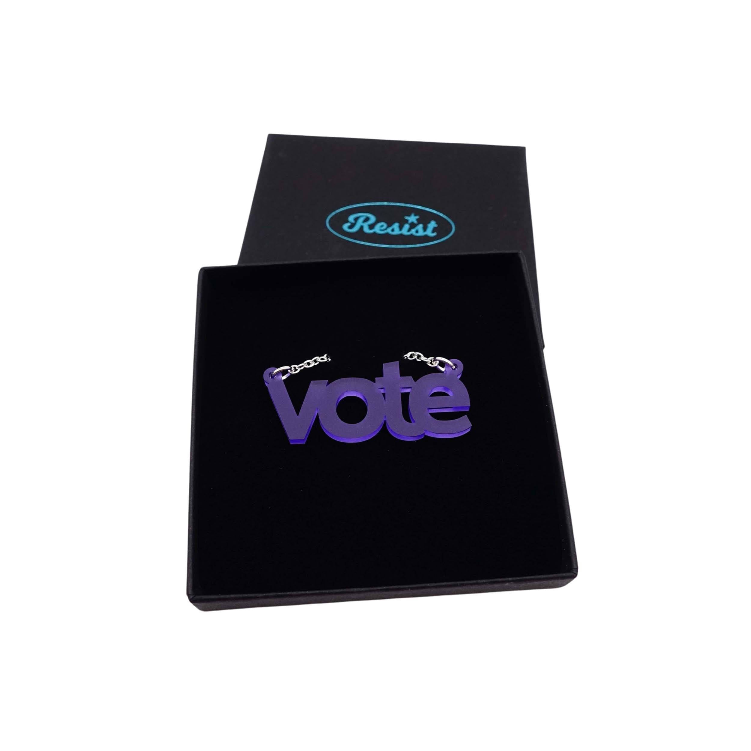 Vote necklace in violet frost shown in a Wear and Resist gift box.  
