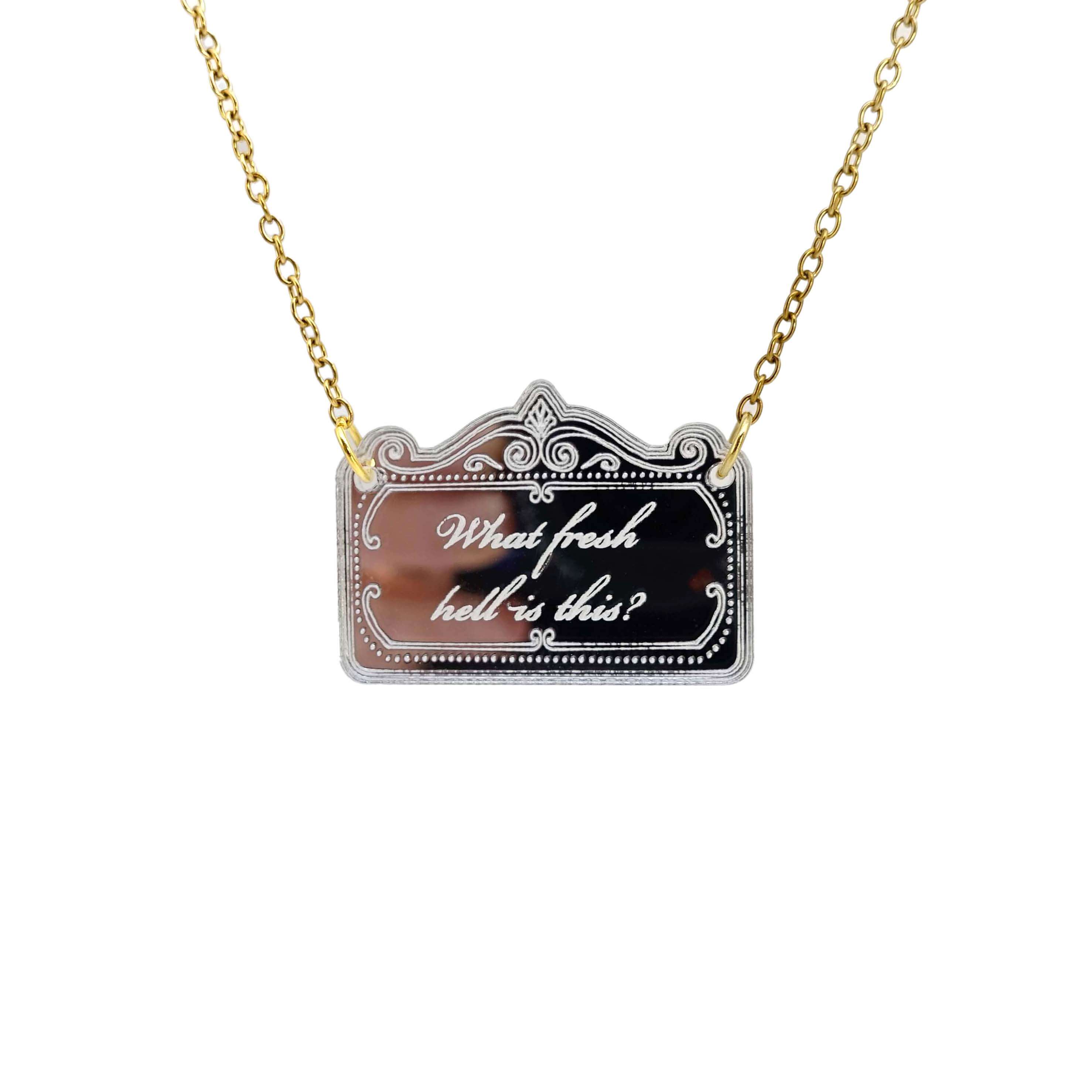 a necklace etched with 'what fresh hell is this?' shown hanging on a gold ion plated stainless steel chain. 