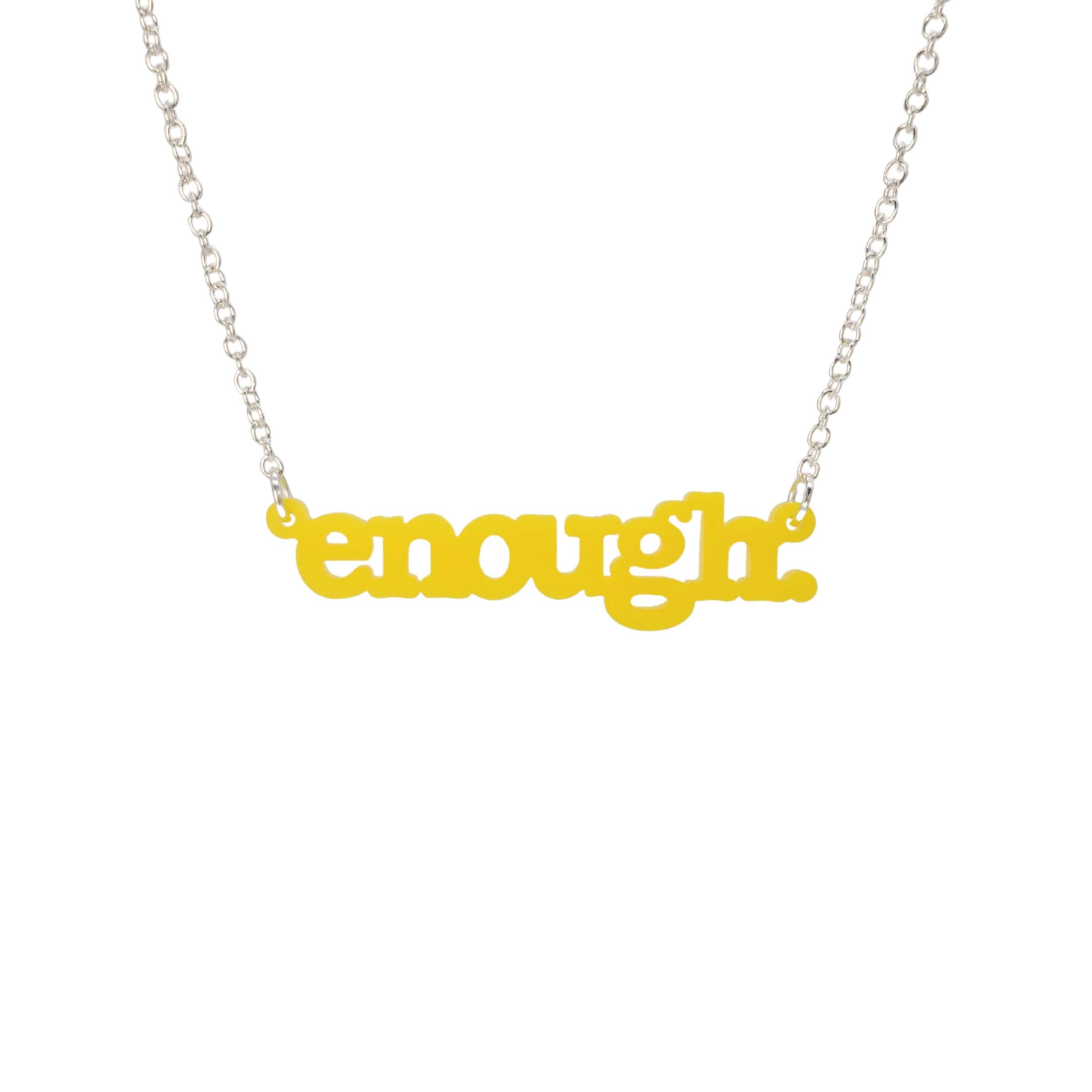 Matte lemon Enough necklace shown hanging on a silver chain against a white background. 