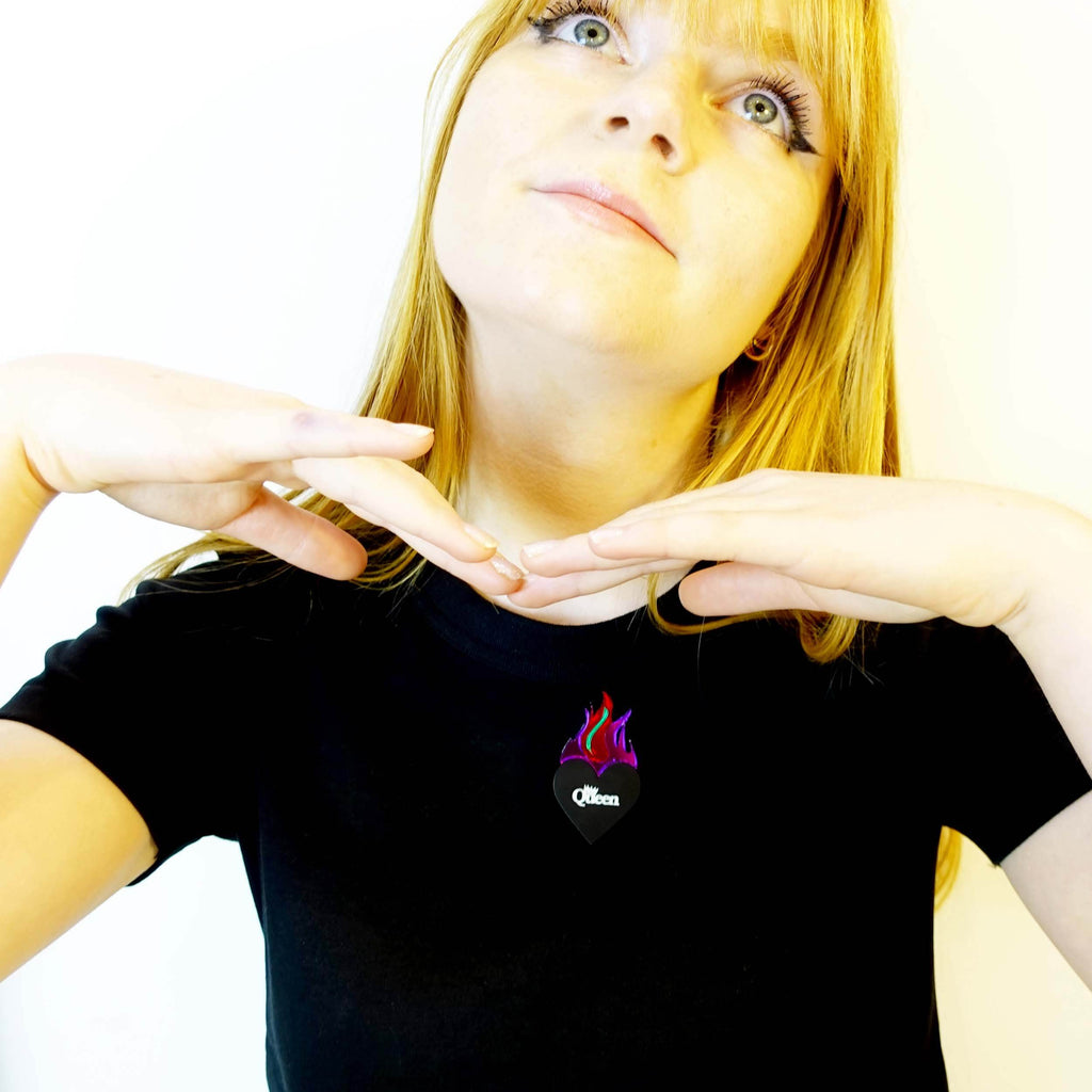 Model wears a flaming heart Queen brooch by Wear and Resist. 
