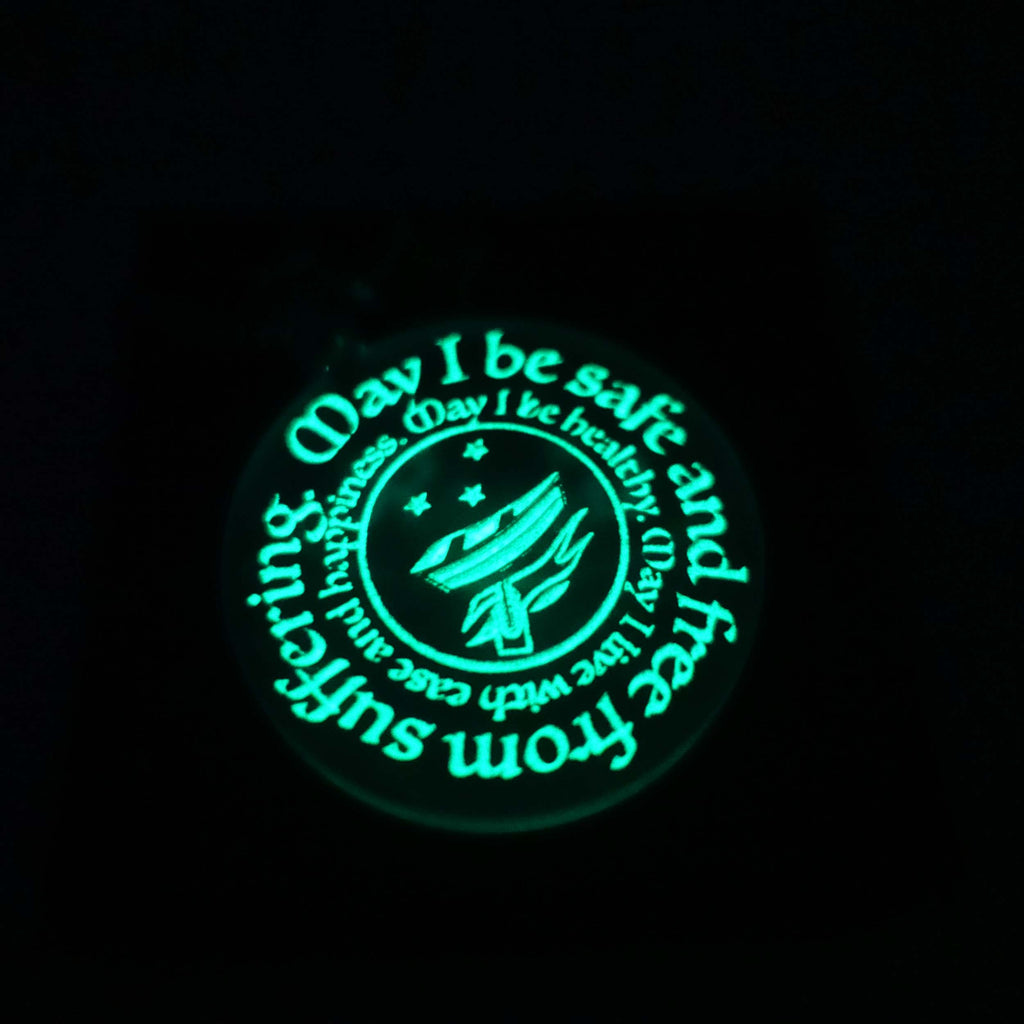 RNLI safe pendant shown glowing in the dark. 