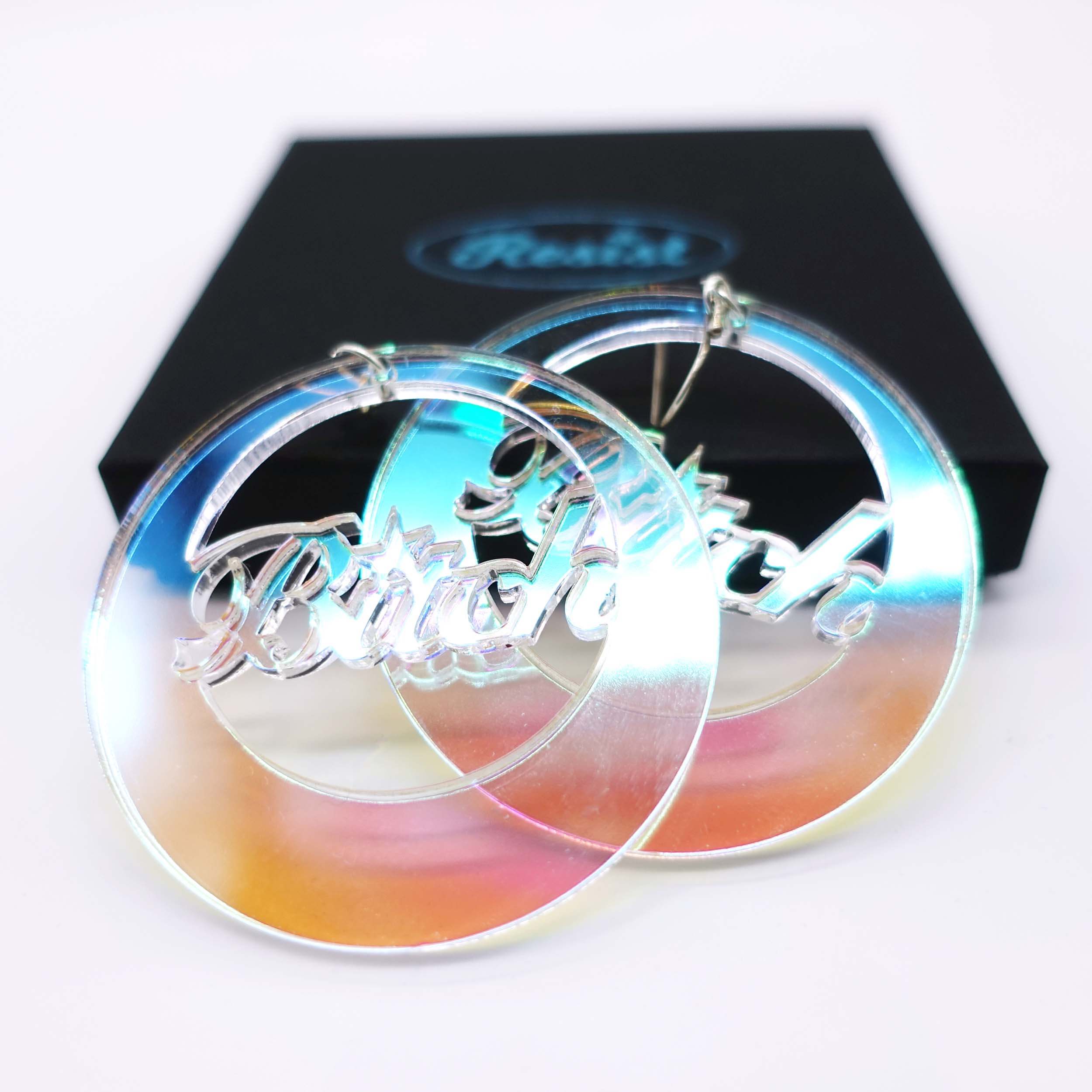B*tch iridescent hoop earrings shown close up with a Wear and Resist gift box. 