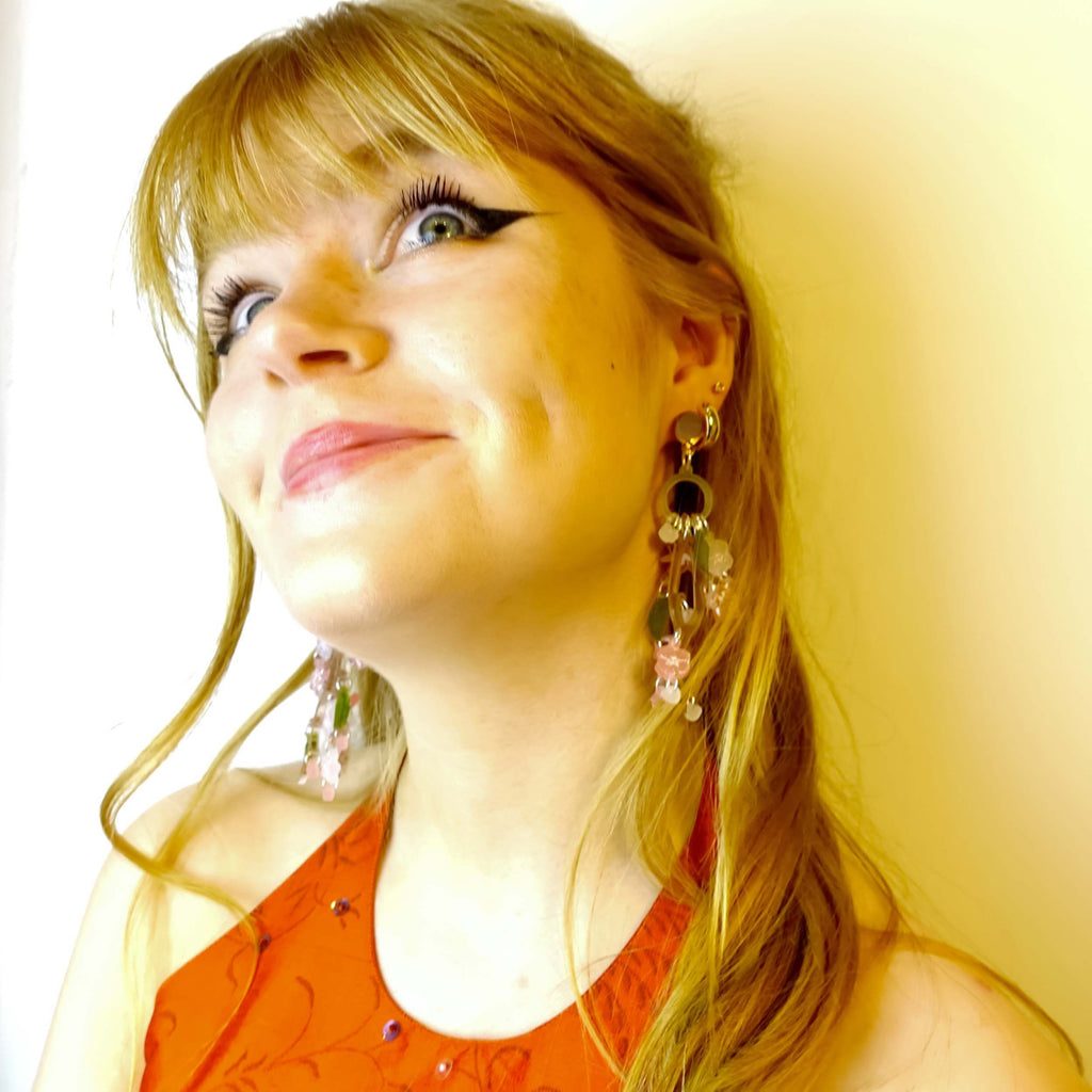 Model wears Cherry Blossom limited edition statement earrings designed by Sarah Day for Wear and Resist.