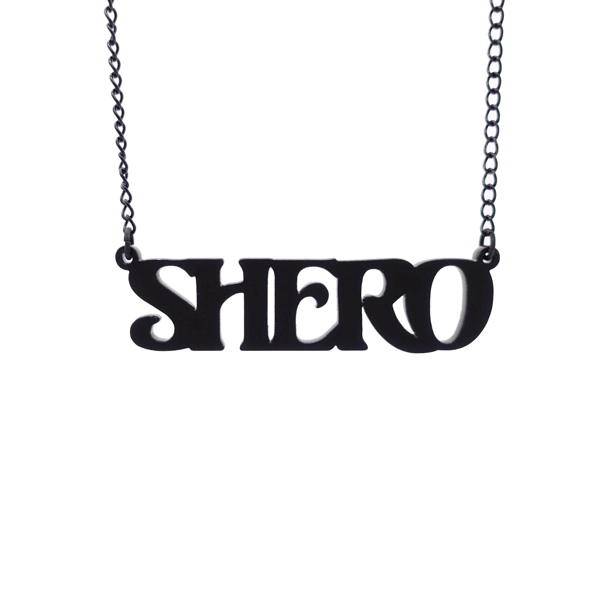 Matte black Shero necklace hanging against a white background. 