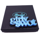 Sky mirror Girly Swot brooch shown on a Wear and Resist gift box. Who are you calling a Girly Swot?