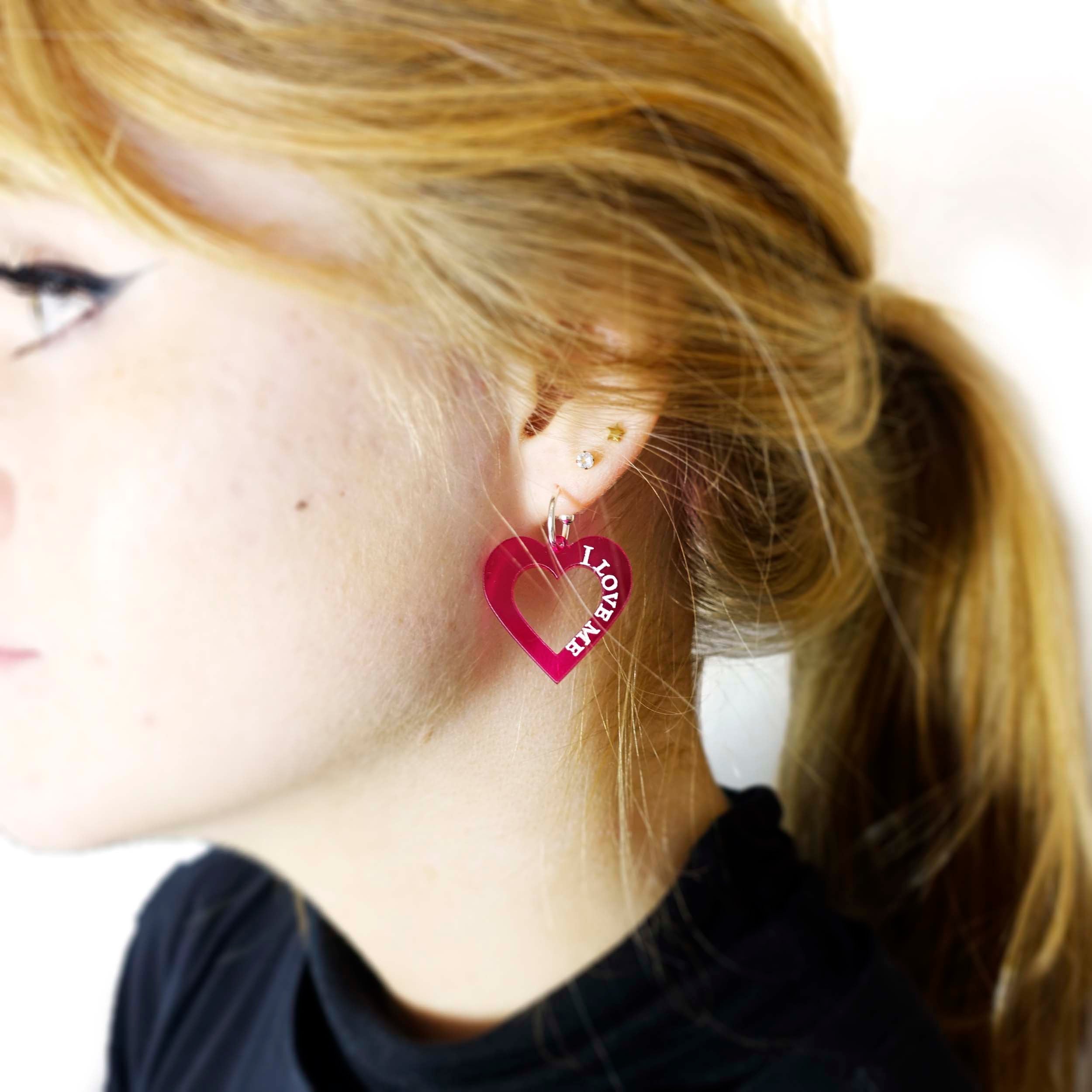 Eliza wears hot pink I love me heart hoops designed by Sarah Day for Wear and Resist. 