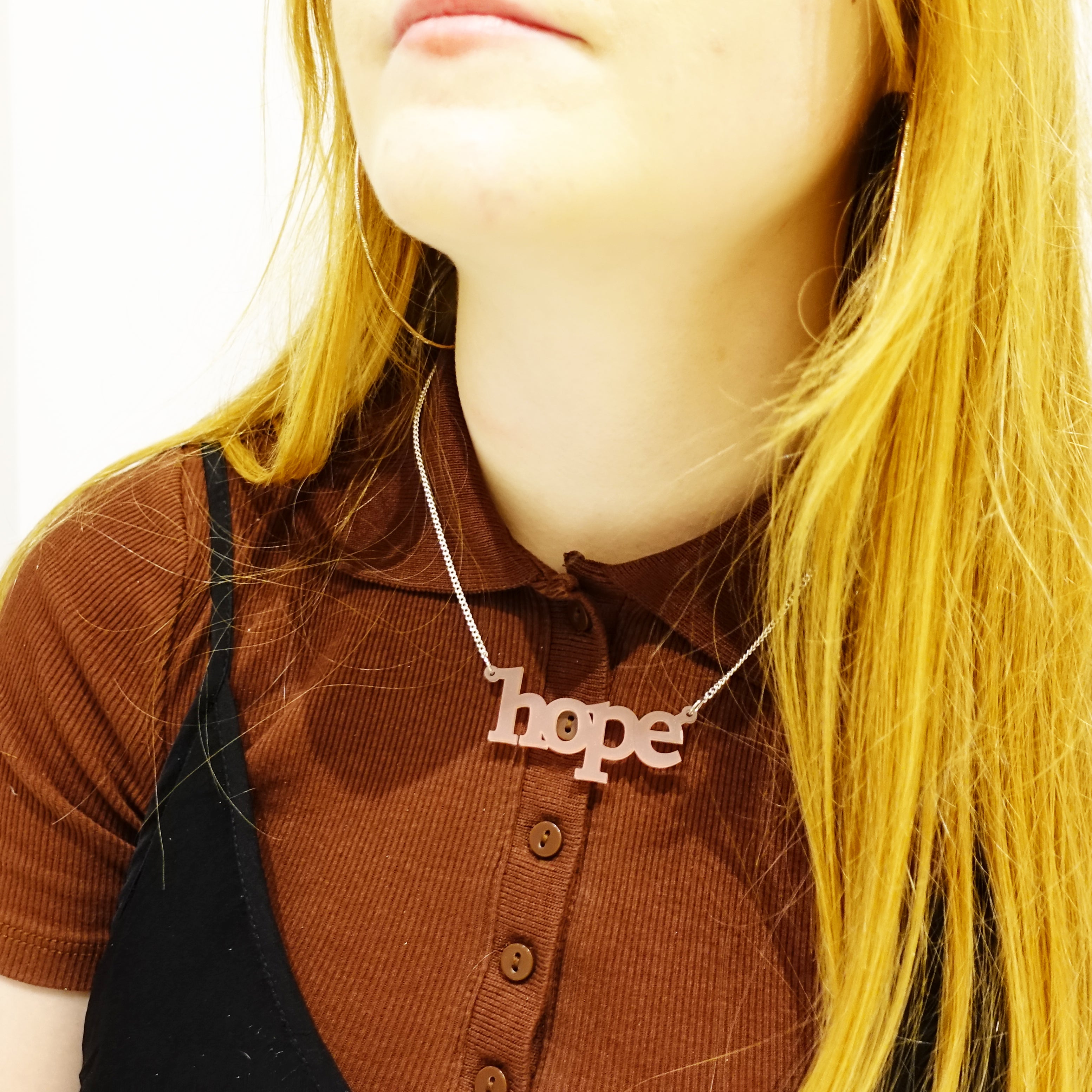 Model wears blush frost Hope necklace. Give someone the gift of hope. 