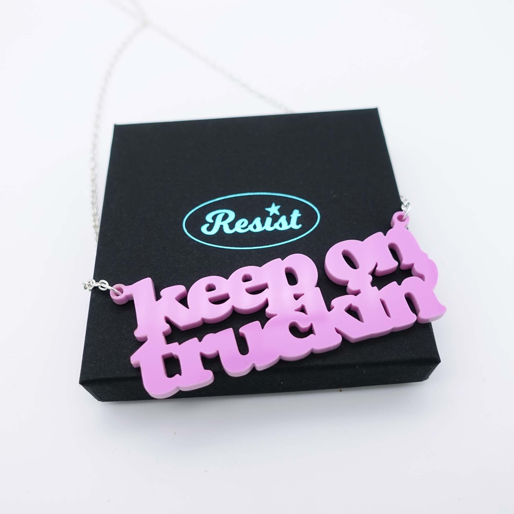 bubblegum pink Keep on Truckin' necklace shown on box