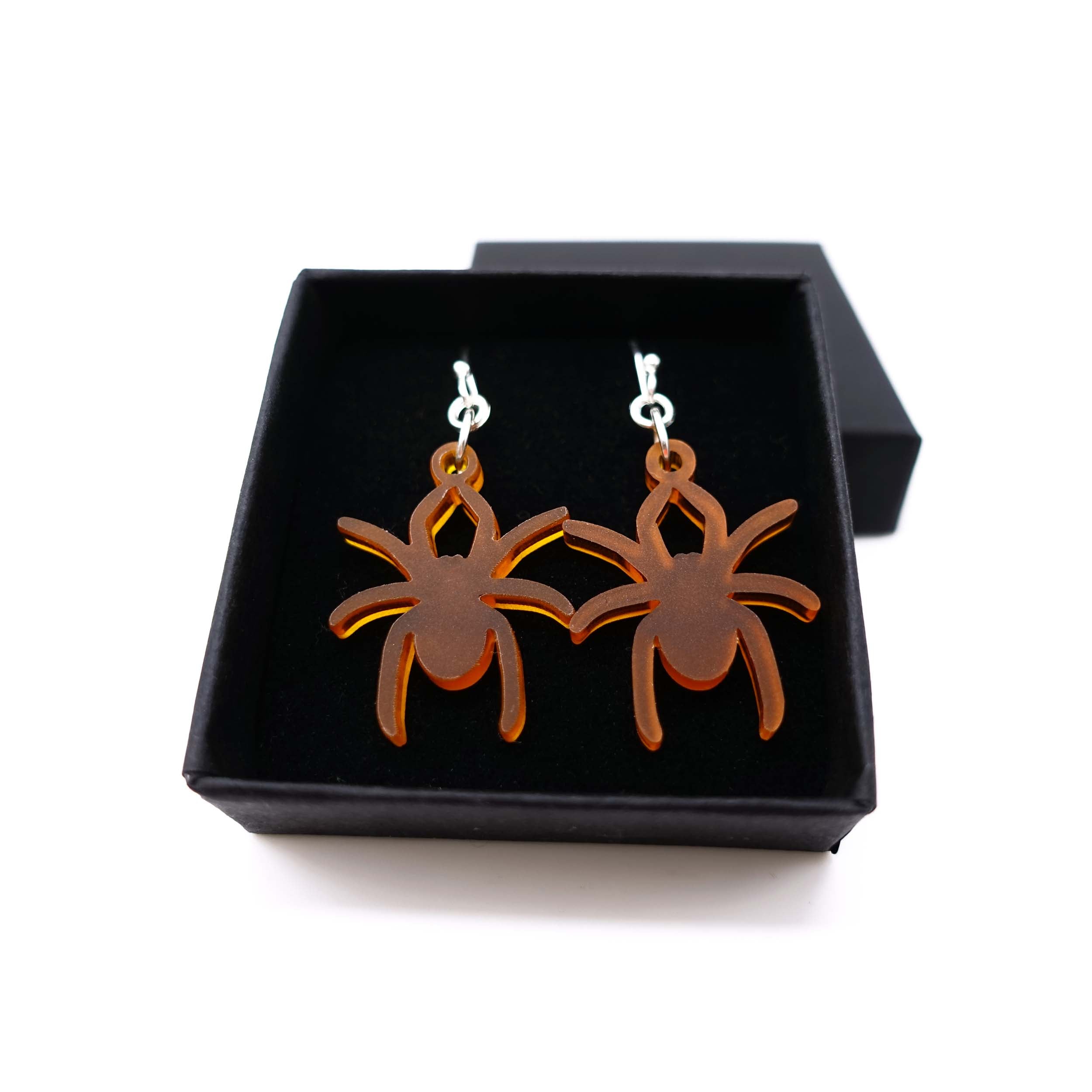 Lady Hale commemorative spider earrings in cider frost shown in box.