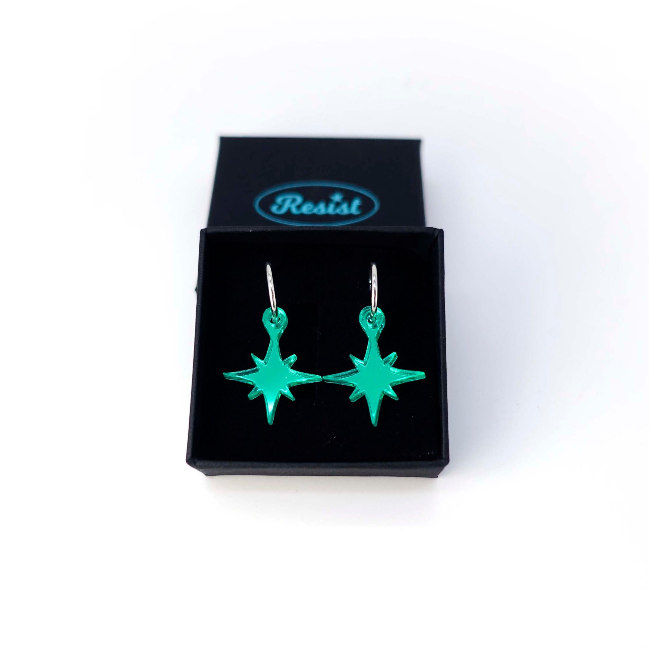 Electric green mirror vintage star earrings shown in a Wear and Resist gift box. 