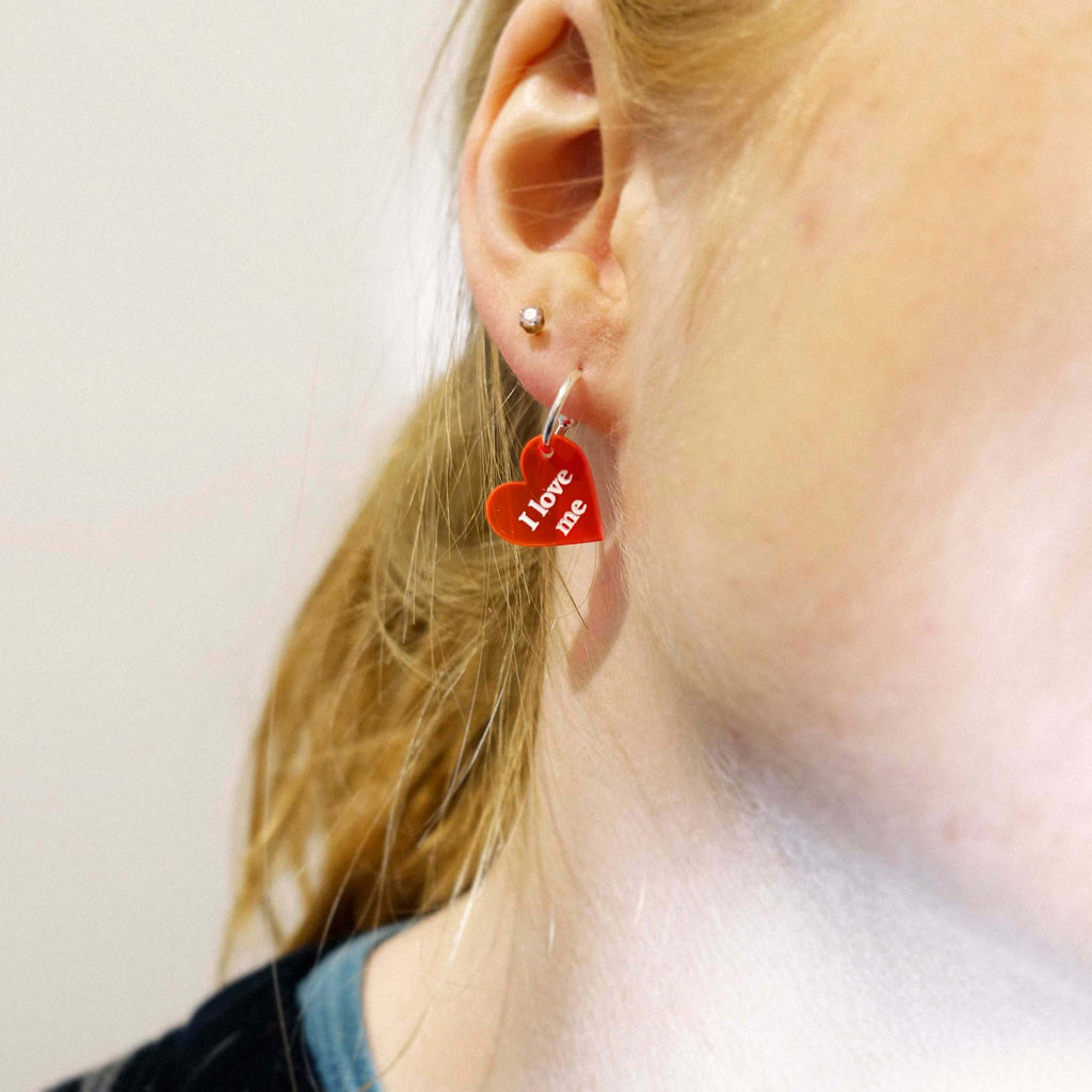Eliza wears little I love me hearts on sterling silver hoops, designed by Sarah Day for Wear and Resist. 