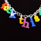 Close up of F*ck this sh*t necklace in retro alphabet letters designed by Sarah Day for Wear and Resist. 