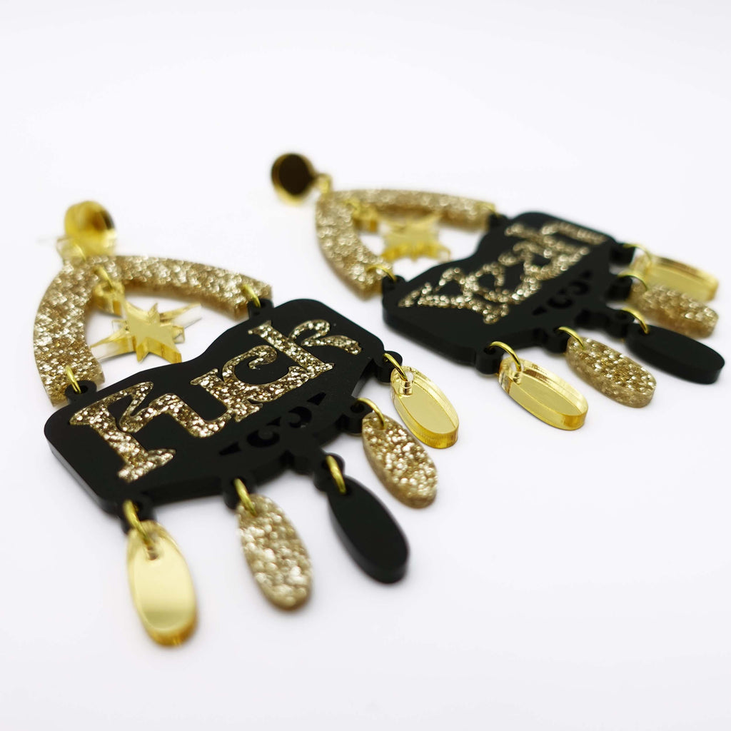 Fuck yeah earrings in black and gold glitter shown on white background