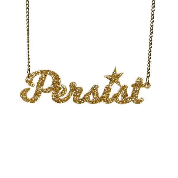 Gold glitter script Persist necklace shown hanging against a white background. 