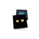 Gold mirror mirror tiny heart stud earrings shown in a Wear and Resist gift box. 