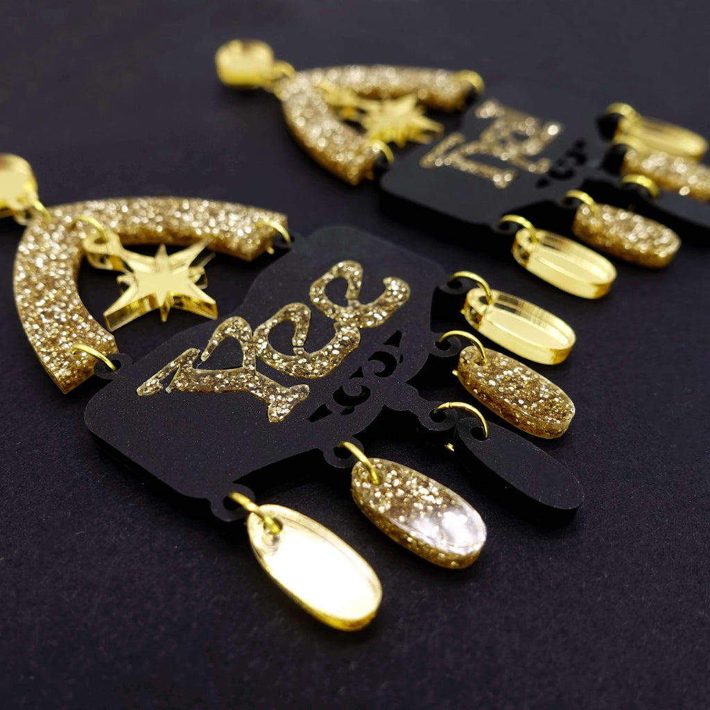 Yee Ha statement earrings in gold glitter by Wear and Resist. 