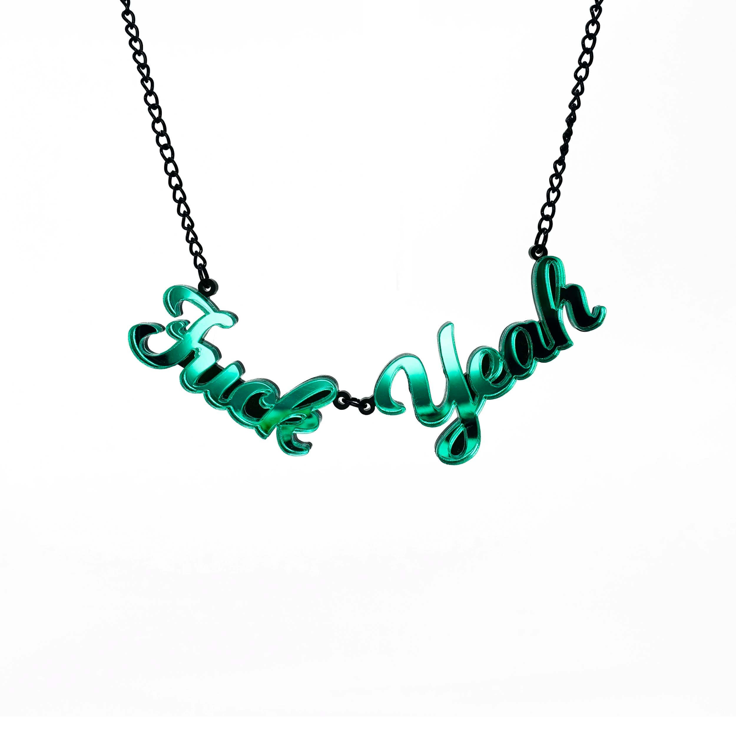 Electric green mirror F*ck Yeah necklace shown hanging on white. Designed by Sarah Day for Wear and Resist. £2 goes to Bloody Good Period. 