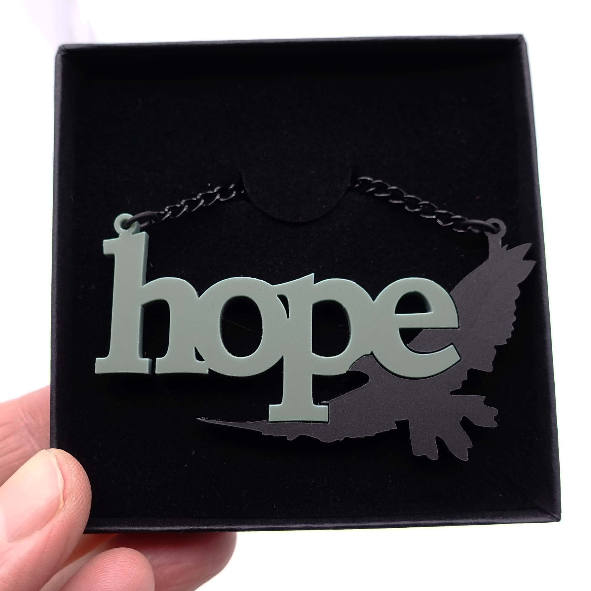 Terre verte and matte black Hope is the Thing with Feathers necklace in box