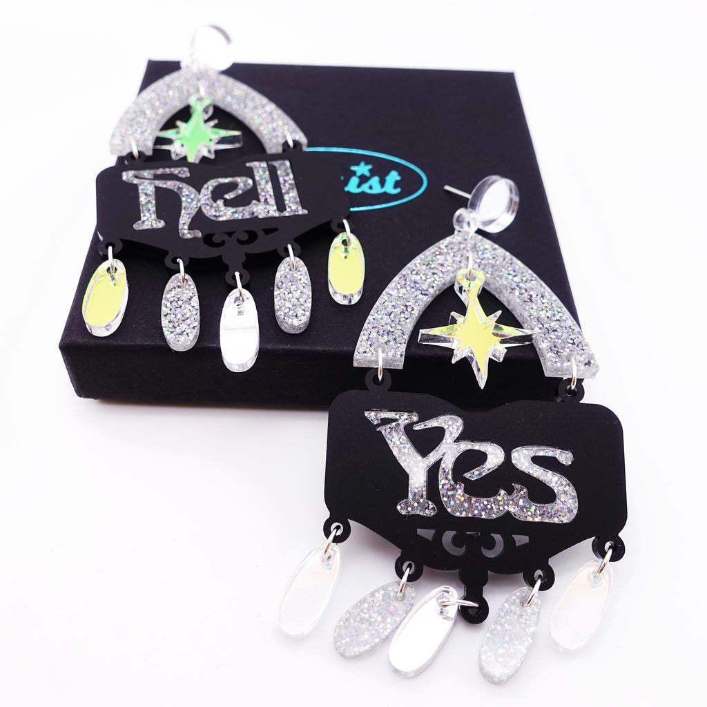 Silver glitter Hell Yes statement earrings on gift box