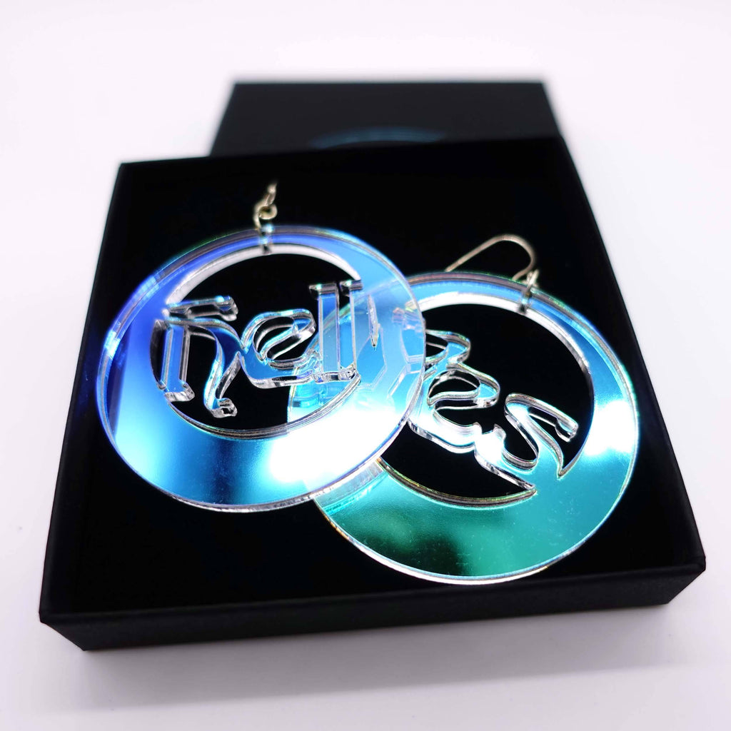 Hell Yes hoop earrings in iridescent acrylic shown in a  Wear and Resist gift box. 