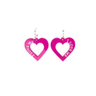 Hot pink I love me heart hoops shown hanging on a white backround.